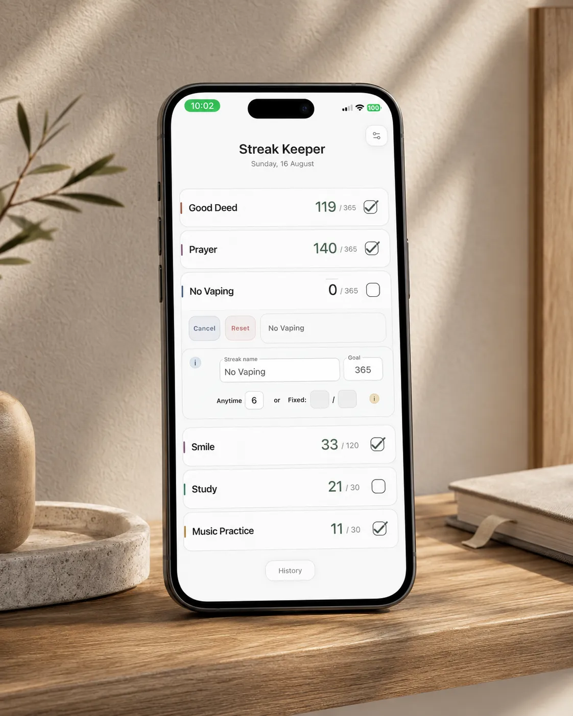 An iPhone showing the Streak Keeper Edit view open for a streak, with its name and goal fields and the Anytime/Fixed Pause Day options visible, other streaks listed below.
